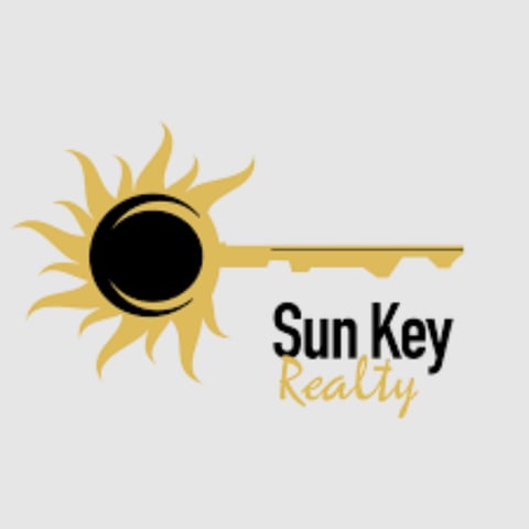 Sun Key Realty logo featuring a stylized sun with a key design and text